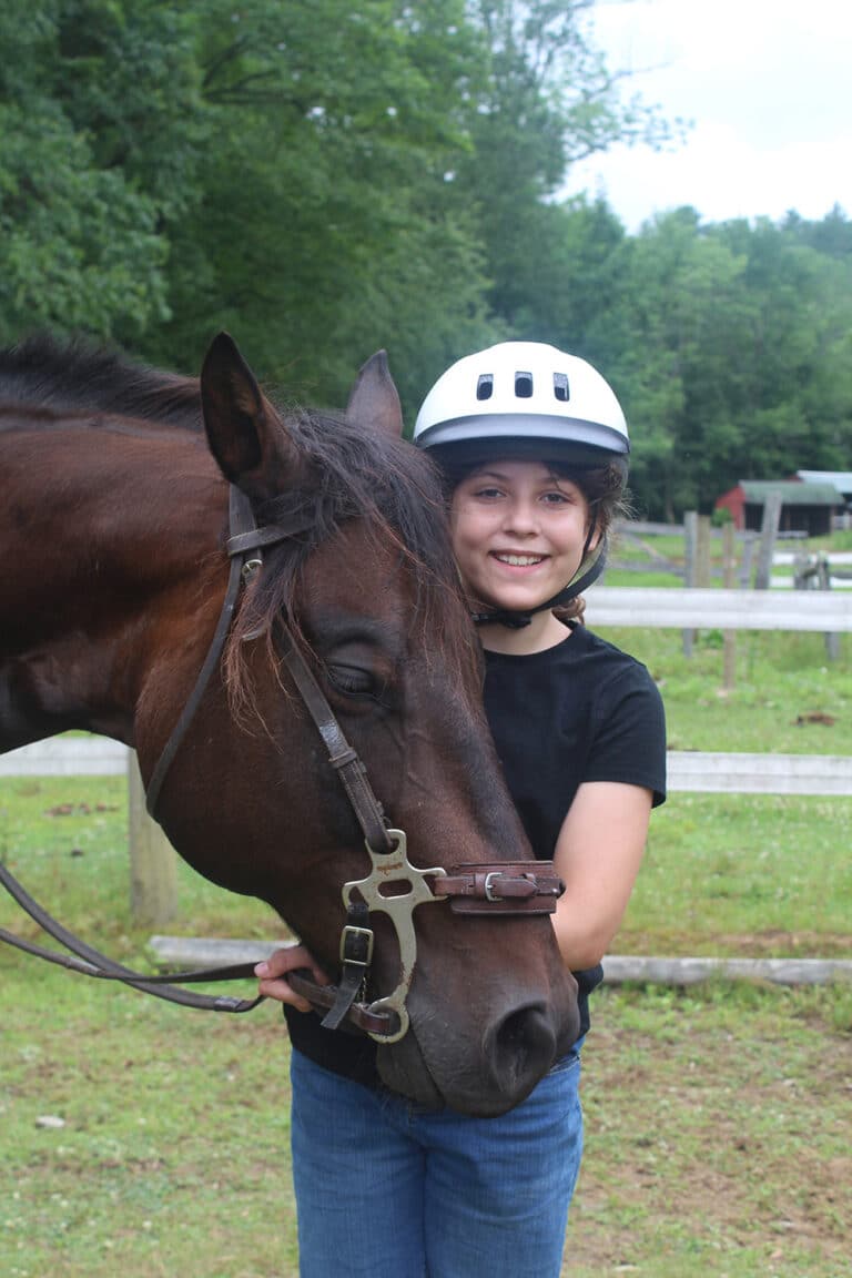 A smiling girl with horse
